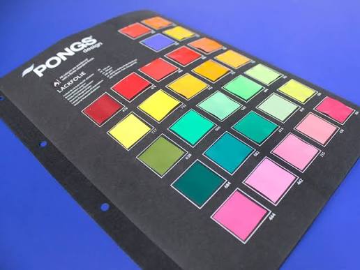 Creative printing materials and design samples arranged on a studio table