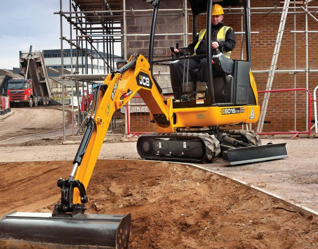 Rental equipment staged with buckets and attachments