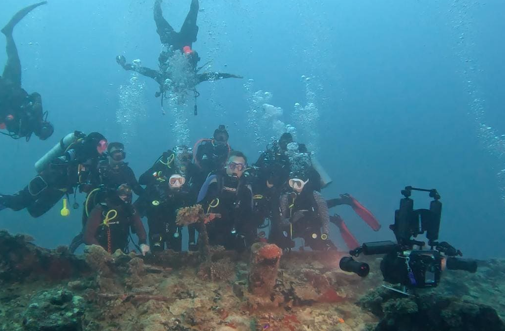 Dive team preparing underwater cameras before a night excursion